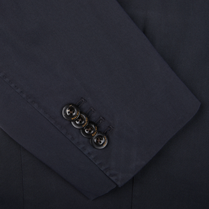 Close-up of an unstructured Boglioli navy blue suit sleeve with four buttons, indicative of K.Jacket's Italian craftsmanship.