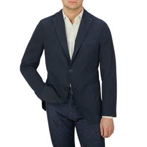 A man wearing a Boglioli Navy Blue Washed Cotton K Jacket, made in Italy, pairing it with jeans.