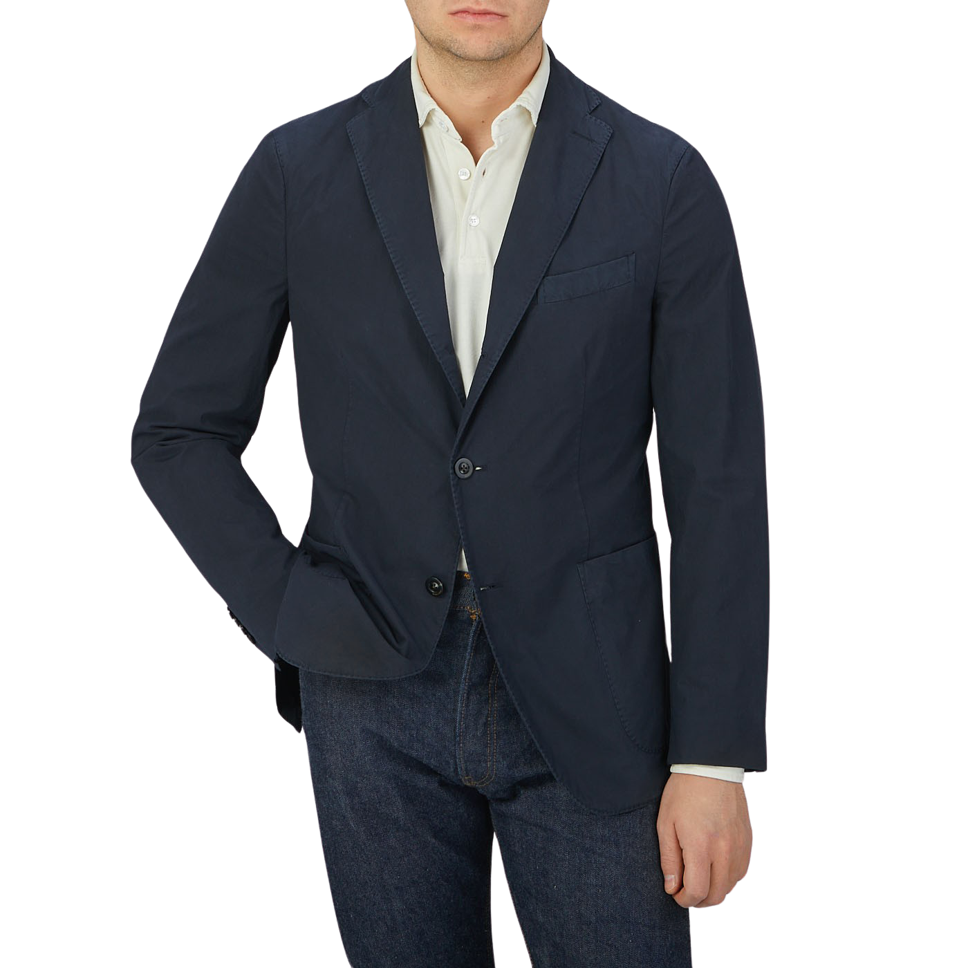 Man wearing an Italian Boglioli Dark Blue Washed Cotton K Jacket with unstructured craftsmanship, cream shirt, and blue jeans.