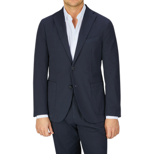 Man wearing an Italian Boglioli Navy Blue Washed Cotton K Jacket with unstructured craftsmanship, fashioned in navy blue and paired with a white shirt.