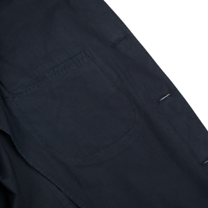 Close-up of a dark Blue Washed Cotton K Jacket fabric by Boglioli with a pocket and button details, showcasing Italy's unstructured craftsmanship.