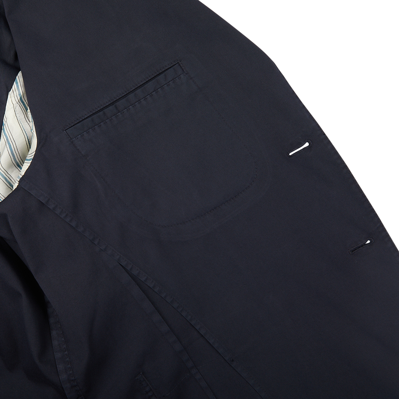 Close-up of a Navy Blue Washed Cotton K Jacket from Boglioli with unstructured craftsmanship from Italy, paired with a striped shirt underneath.