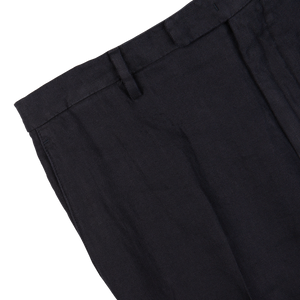 Navy blue washed Irish linen trousers with pleats on a white background, made from pure linen by Boglioli.