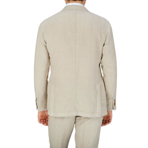The back view of a man wearing a Boglioli Sand Beige Washed Linen Unstructured Suit.