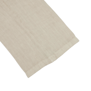 A Sand Beige Washed Linen Unstructured Suit on a white surface, made of beige Boglioli linen fabric.