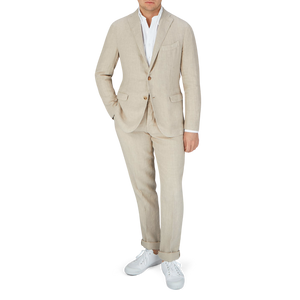 A man in a Boglioli Sand Beige Washed Linen Unstructured Suit, posing for a photo.