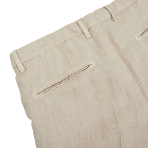 A close up of a Boglioli Sand Beige Washed Linen Unstructured Suit trouser, made with linen fabric.