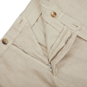 A pair of Boglioli Sand Beige Washed Linen Unstructured Suit pants with zippers on the side, perfect for a stylish suit ensemble.