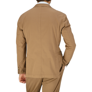 Man standing with his back to the camera wearing a beige, unstructured Boglioli Tobacco Brown Washed Cotton K jacket, crafted in Italy.