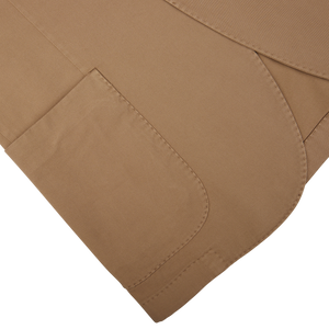 Three overlapping Tobacco Brown Washed Cotton K Jackets with visible stitching on a white background, showcasing unstructured craftsmanship from Boglioli, Italy.