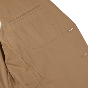Tobacco Brown Washed Cotton K Jacket from Boglioli featuring a close-up view of the pocket and button details, showcasing Italy's unstructured craftsmanship.