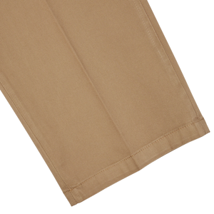 Boglioli's Tobacco Brown Washed Cotton Pleated Trousers with a stitched hem on a white background.
