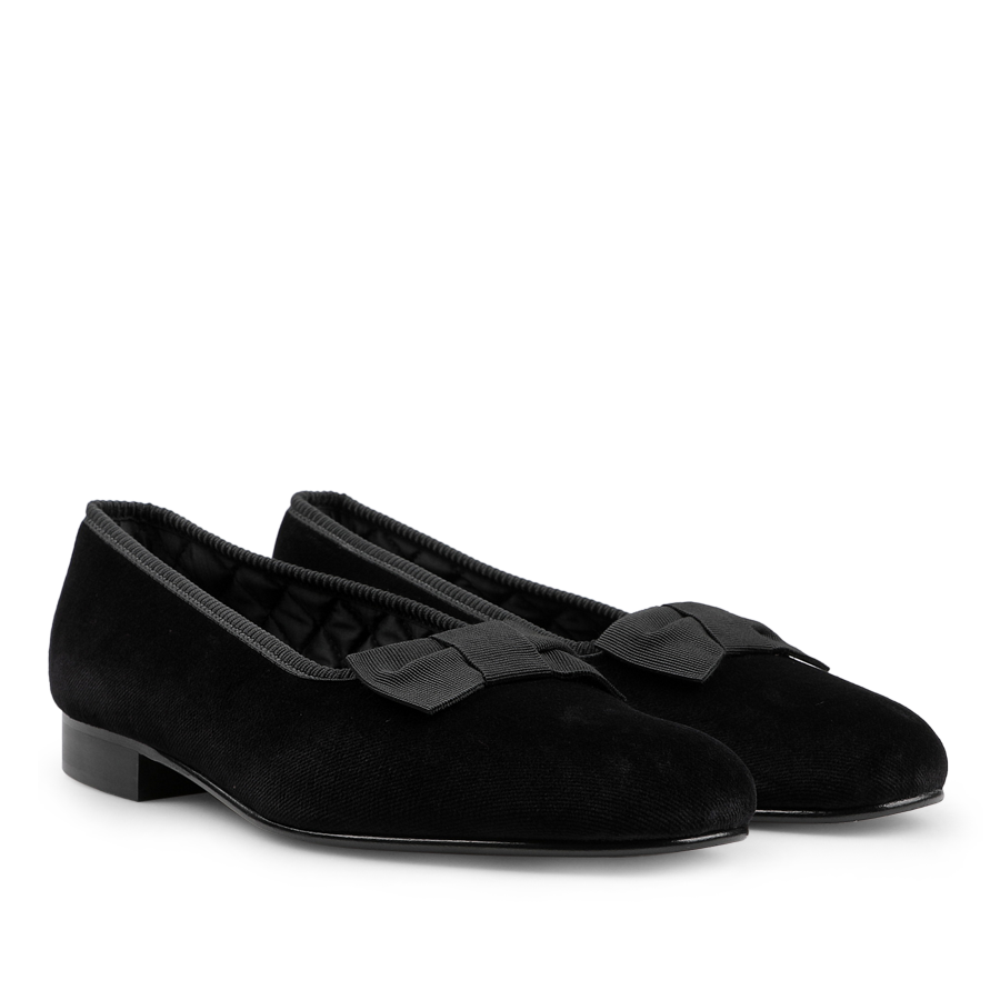 A pair of Bowhill Elliott Black Velvet Bow Opera Pumps with stylish bows on the front, featuring low heels and rounded toes—perfect formal shoes for any occasion.