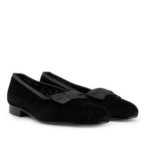 A pair of Bowhill Elliott Black Velvet Bow Opera Pumps with stylish bows on the front, featuring low heels and rounded toes—perfect formal shoes for any occasion.