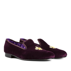 A pair of Regal Purple Velvet Fleur de Lys slippers by Bowhill Elliott with embroidered gold motifs on the upper.