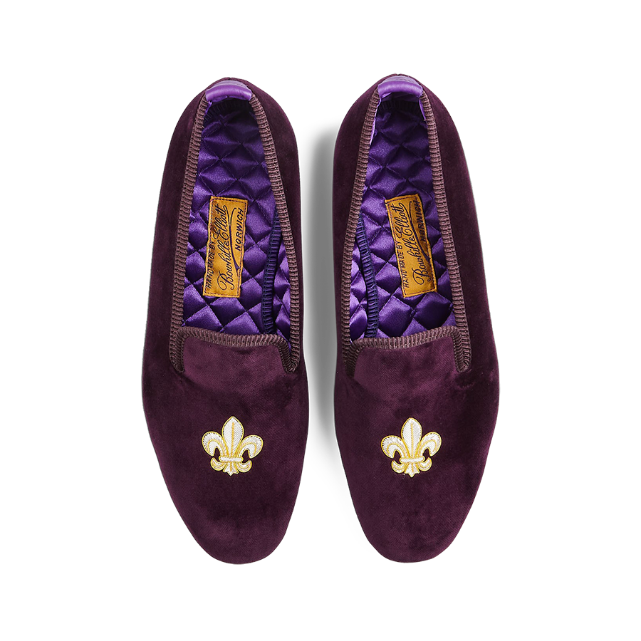 A pair of Regal Purple Velvet Fleur de Lys Slippers with embroidered gold fleur-de-lis motifs by Bowhill Elliott.