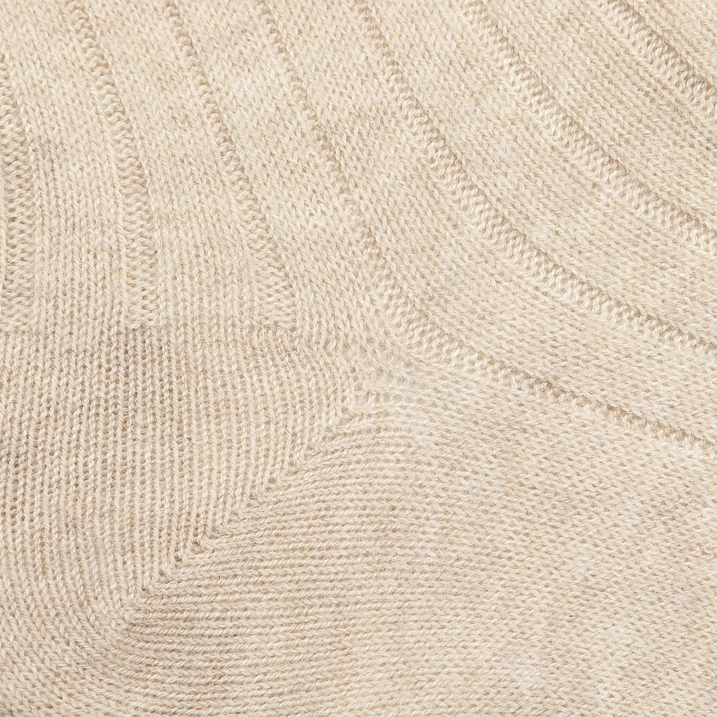 Close-up of a luxurious wool-cashmere blend knitted fabric with a ribbed texture, reminiscent of the Beige Ribbed Wool Cashmere Socks by Bresciani, Made in Italy.