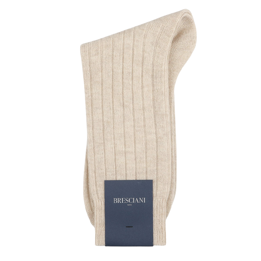 The Beige Ribbed Wool Cashmere Socks from Bresciani are skillfully made in Italy, showcasing a luxurious wool-cashmere blend and featuring a distinctive blue label adorned with "Bresciani" in sharp white lettering, combining comfort with style.