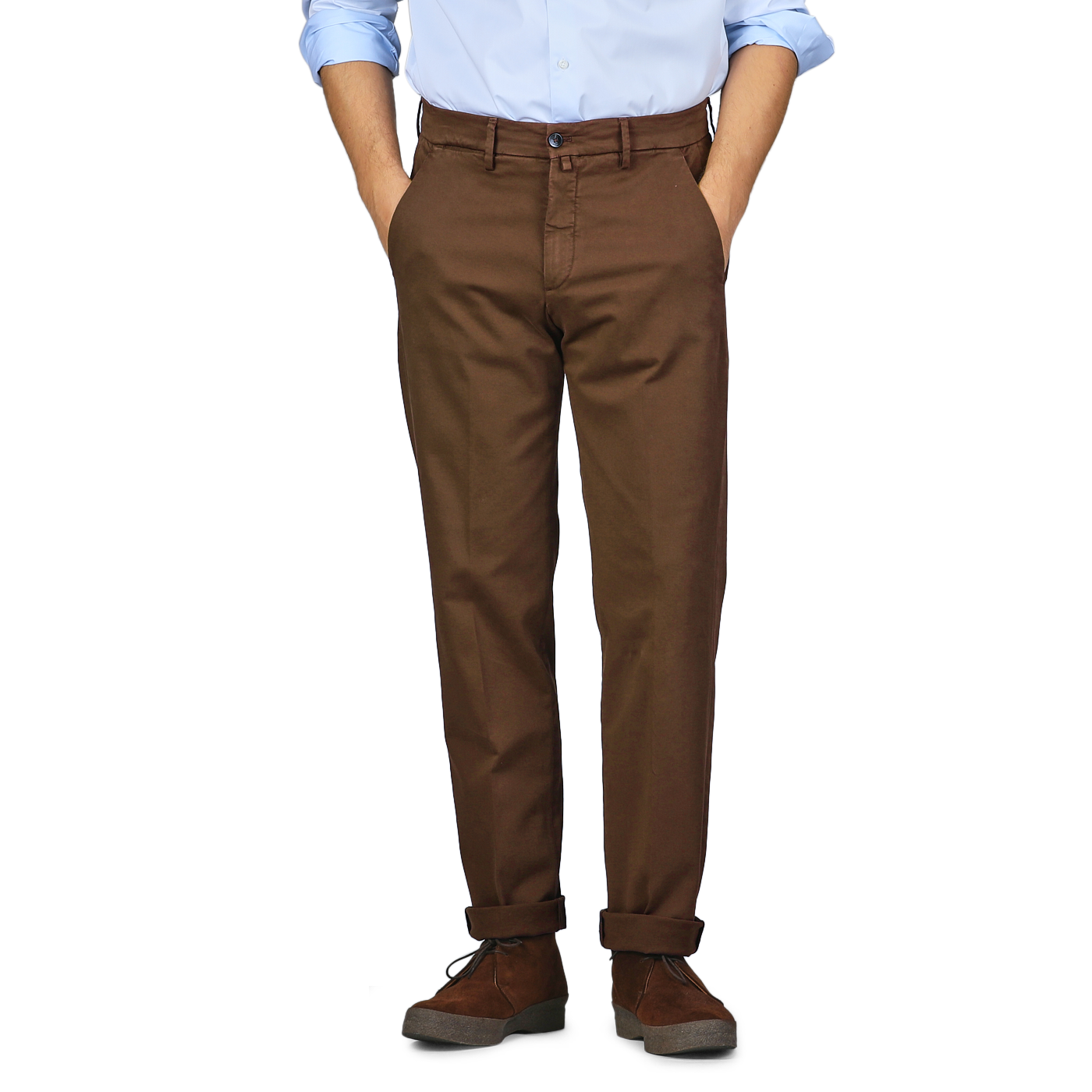 A person in a light blue shirt and Briglia's Brown Cotton Stretch Soho Trousers stands against a plain background with their hands in their pockets. They are wearing dark brown shoes with a thick sole.