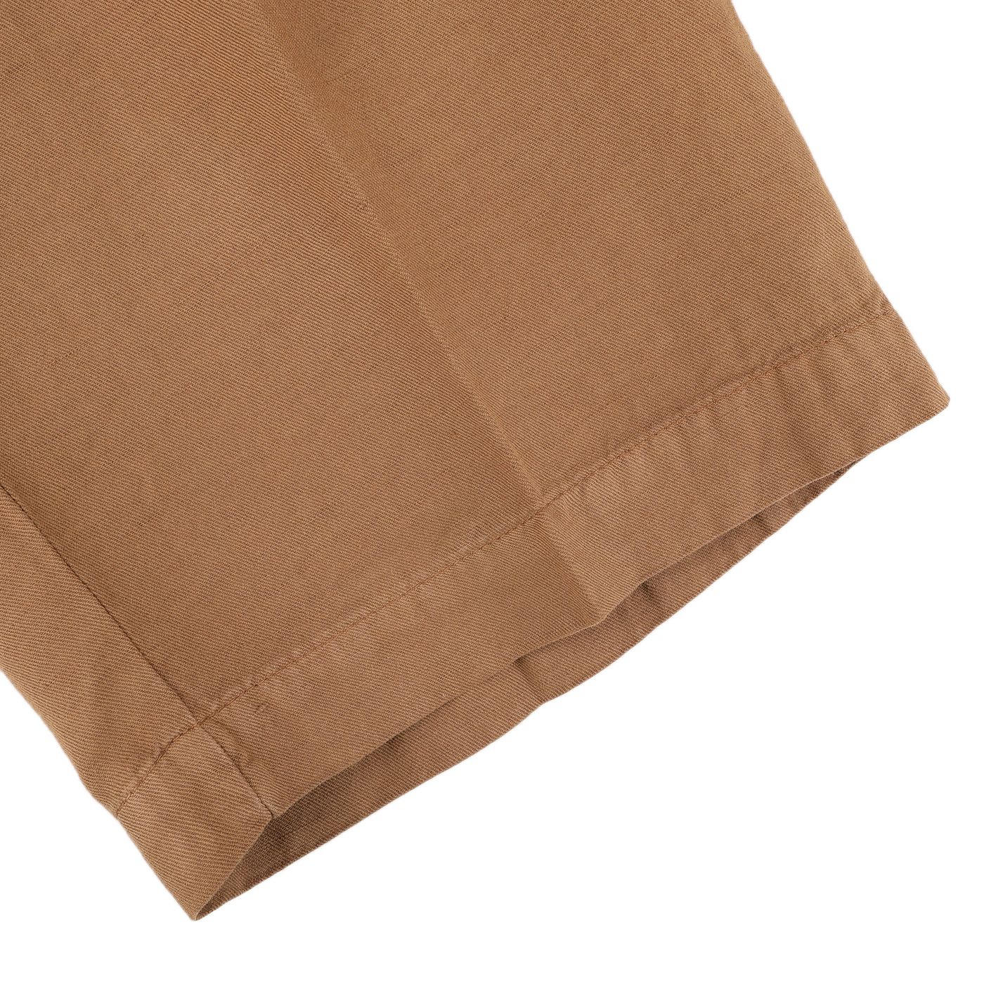 Close-up of the hem of Briglia's Camel Brown Cotton Linen Drawstring Malibu Shorts, showcasing intricate fabric texture and stitching details against a pristine white background.