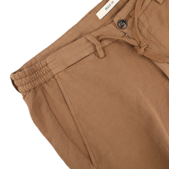 A pair of Briglia Camel Brown Cotton Linen Drawstring Malibu Shorts, with a comfy elastic waistband and button closure, is neatly folded on a flat surface.