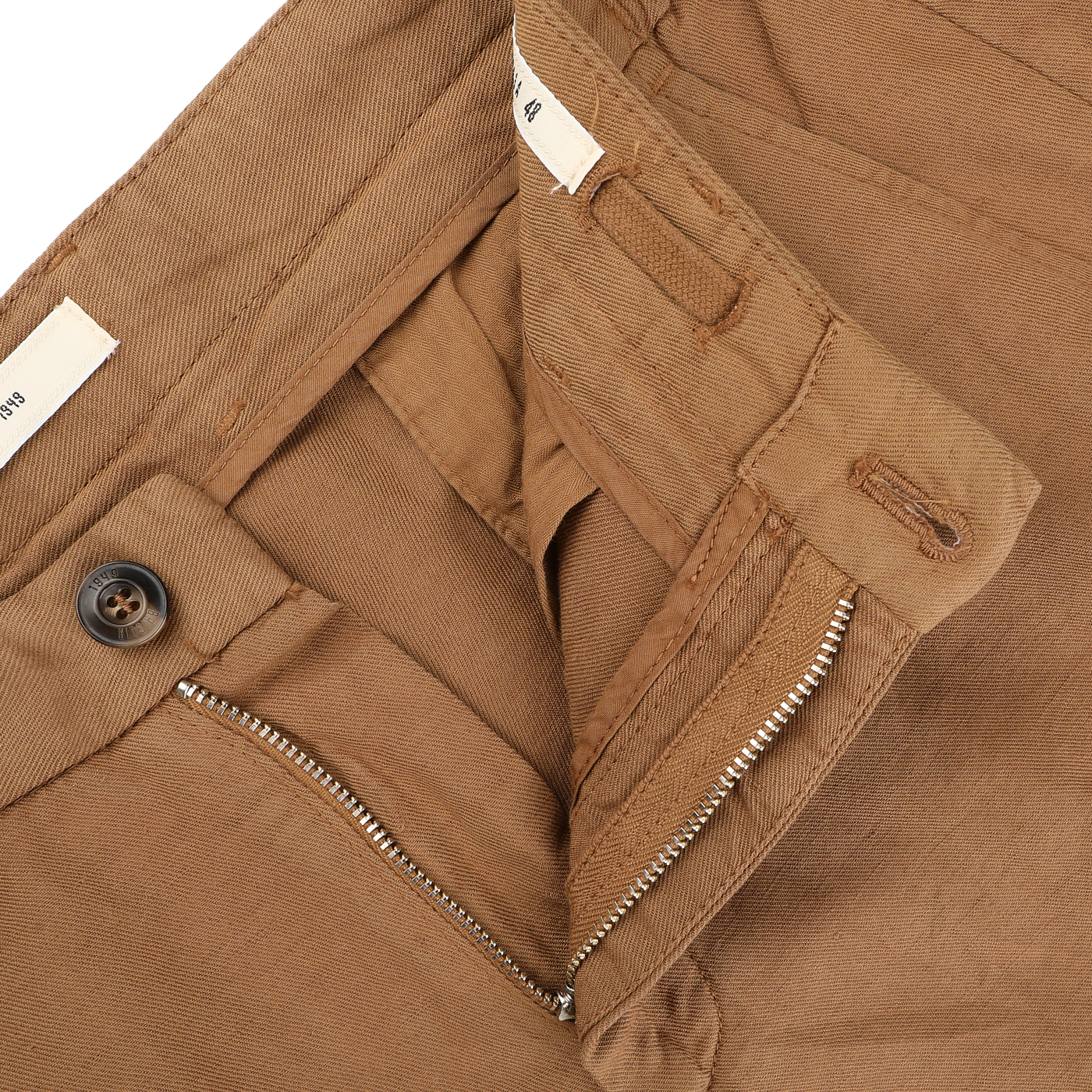 Close-up of Briglia's Camel Brown Cotton Linen Drawstring Malibu Shorts, showcasing visible stitching, a partially open zipper, and a brown button. The waistband reveals a tag, exuding casual elegance.