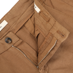 Close-up of Briglia's Camel Brown Cotton Linen Drawstring Malibu Shorts, showcasing visible stitching, a partially open zipper, and a brown button. The waistband reveals a tag, exuding casual elegance.