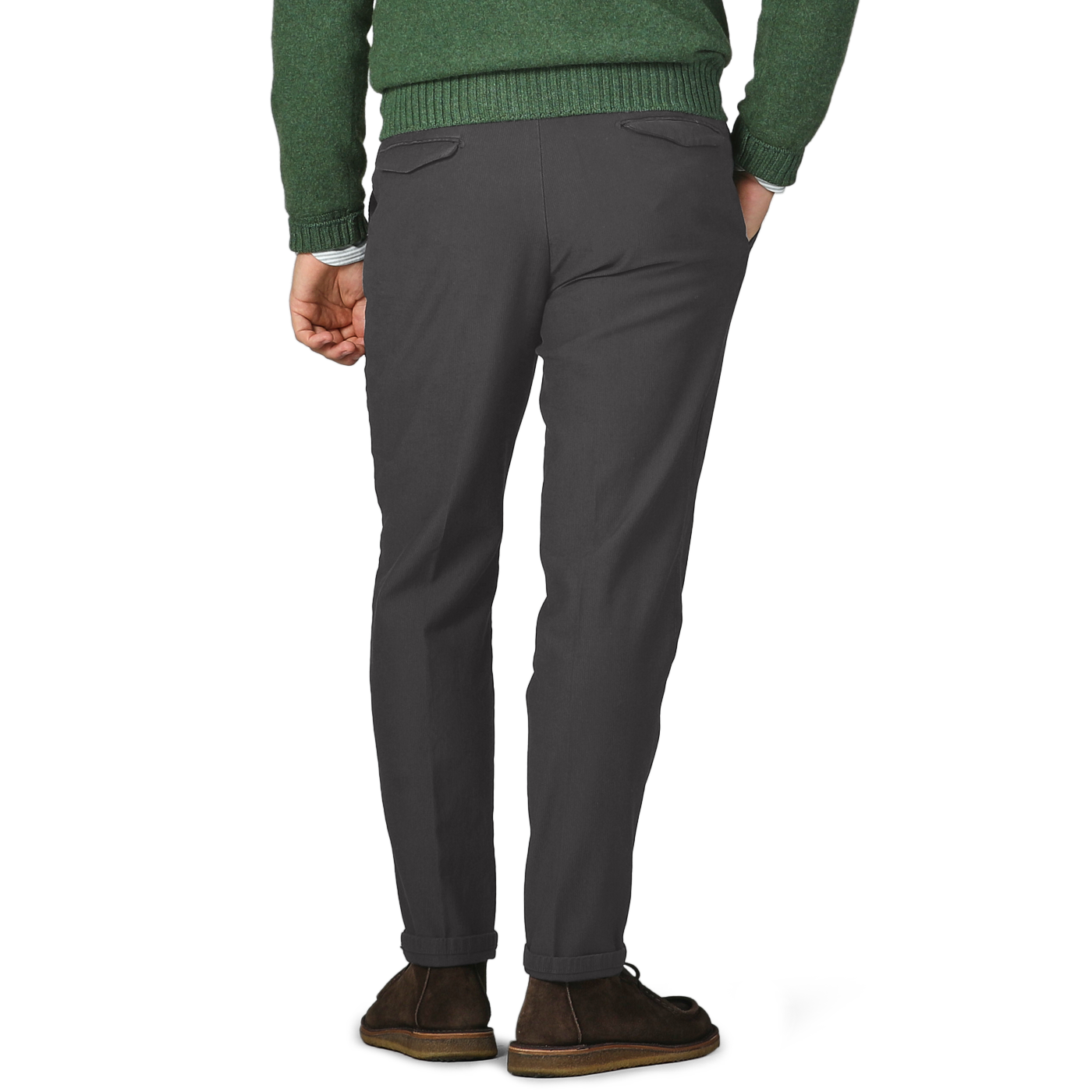 A person wearing Briglia's Dark Grey Cotton Twill BG21 Pleated Trousers and a green sweater, complemented by brown shoes, stands with hands in pockets, facing away.