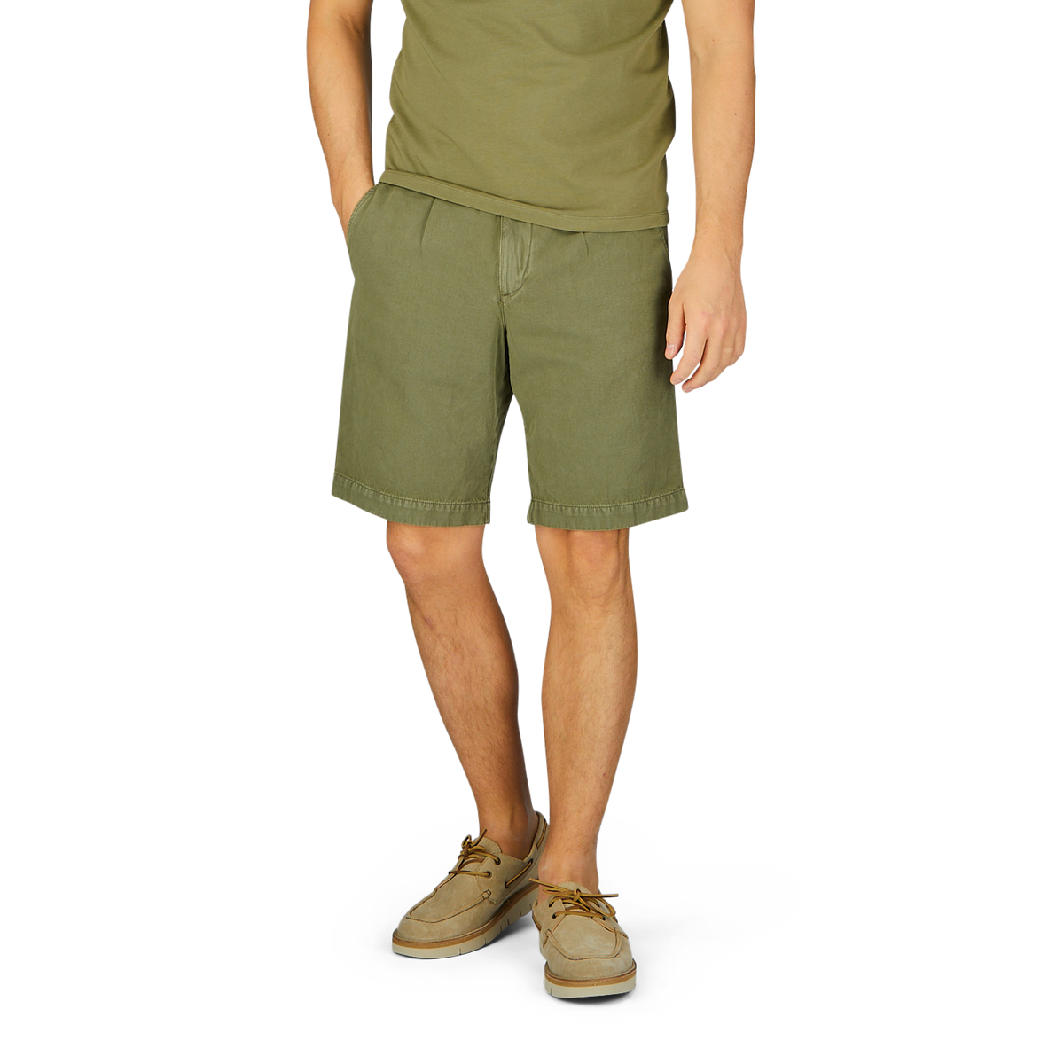 Man wearing Briglia's grass green cotton linen pleated shorts with an adjustable waistband and tan shoes standing against a neutral background.