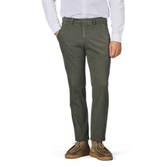 A person wearing a white shirt and Briglia Moss Green Cotton Stretch BG62 Trousers stands with their hands in their pockets. The photo is cropped above the neck and below the ankles.