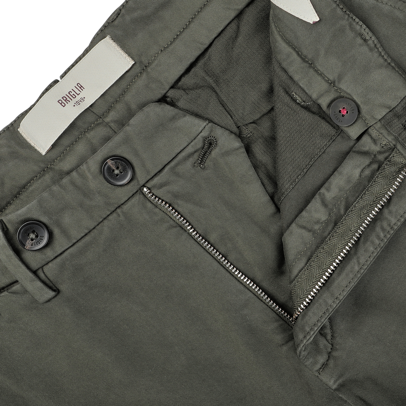 Close-up of an open zipper and button fastening on a pair of slim fit, moss green BG62 trousers. The waistband label reads "Briglia," showcasing the fine craftsmanship in cotton stretch fabric.