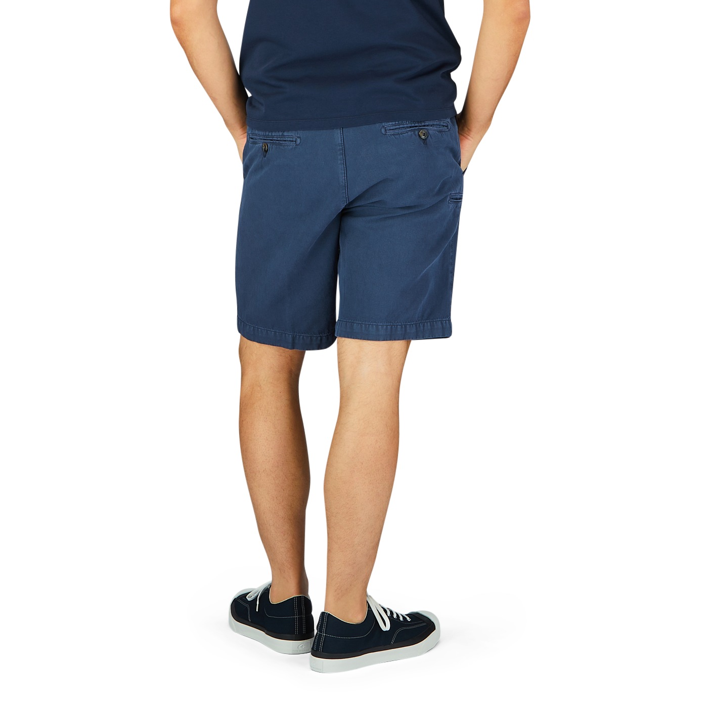 Person standing with hands in pockets, wearing Briglia navy blue cotton linen pleated shorts with an adjustable waistband and sneakers.