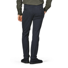 A person wearing Briglia's Navy Blue Cotton Stretch BG62 Trousers, a dark green long-sleeve shirt made from cotton twill, and black shoes is standing with the back facing the camera.