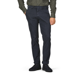 A person wearing a dark green shirt, Navy Blue Cotton Stretch BG62 Trousers by Briglia, and black shoes stands with hands in pockets against a plain background. The person's face is not visible in the image.