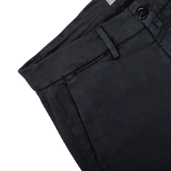 Close-up of Briglia's Navy Blue Cotton Stretch Soho Trousers featuring a single black button on the waistband and a visible belt loop. The material is smooth, woven cotton twill. The background is plain light gray.