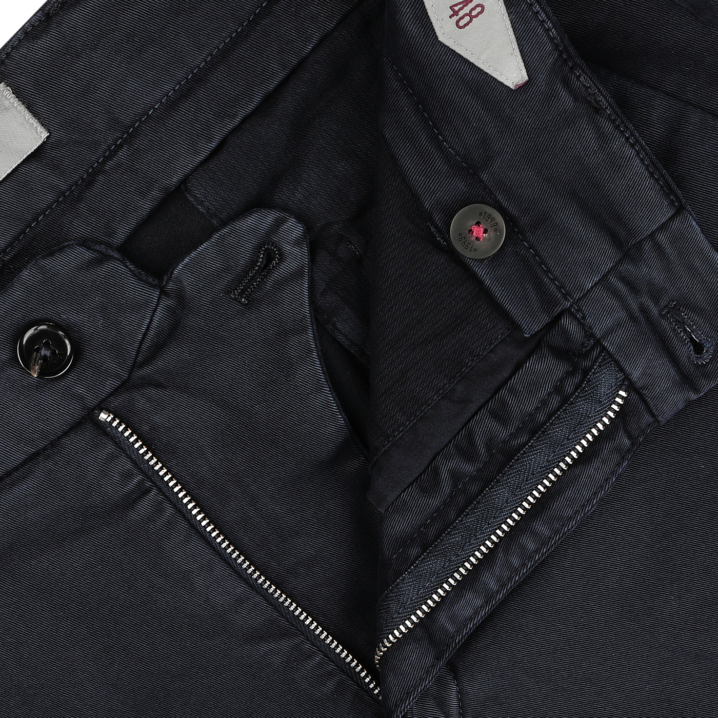 Close-up image of the waistband and zipper fly of a pair of Briglia Navy Blue Cotton Stretch Soho Trousers, displaying the button, zipper, belt loops, and size label. These regular fit pants are crafted from durable cotton twill for comfort and style.