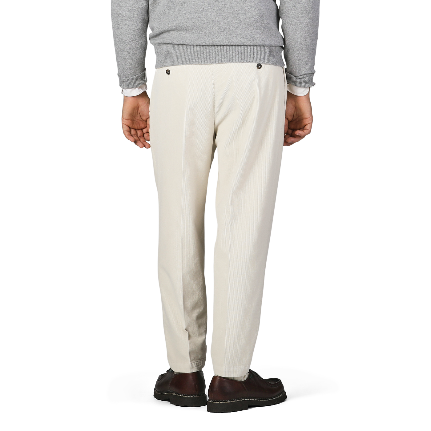 Rear view of a person wearing a gray sweater, Off White Corduroy Courmayeur Trousers by Briglia, and brown shoes, standing against a plain background.