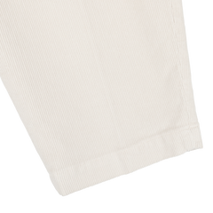 Close-up of the hem of Briglia's Off White Corduroy Courmayeur Trousers, showcasing the cream-colored, ribbed fabric reminiscent of classic chinos. The seamless stitching and vertical lines of the cotton corduroy texture are visible.