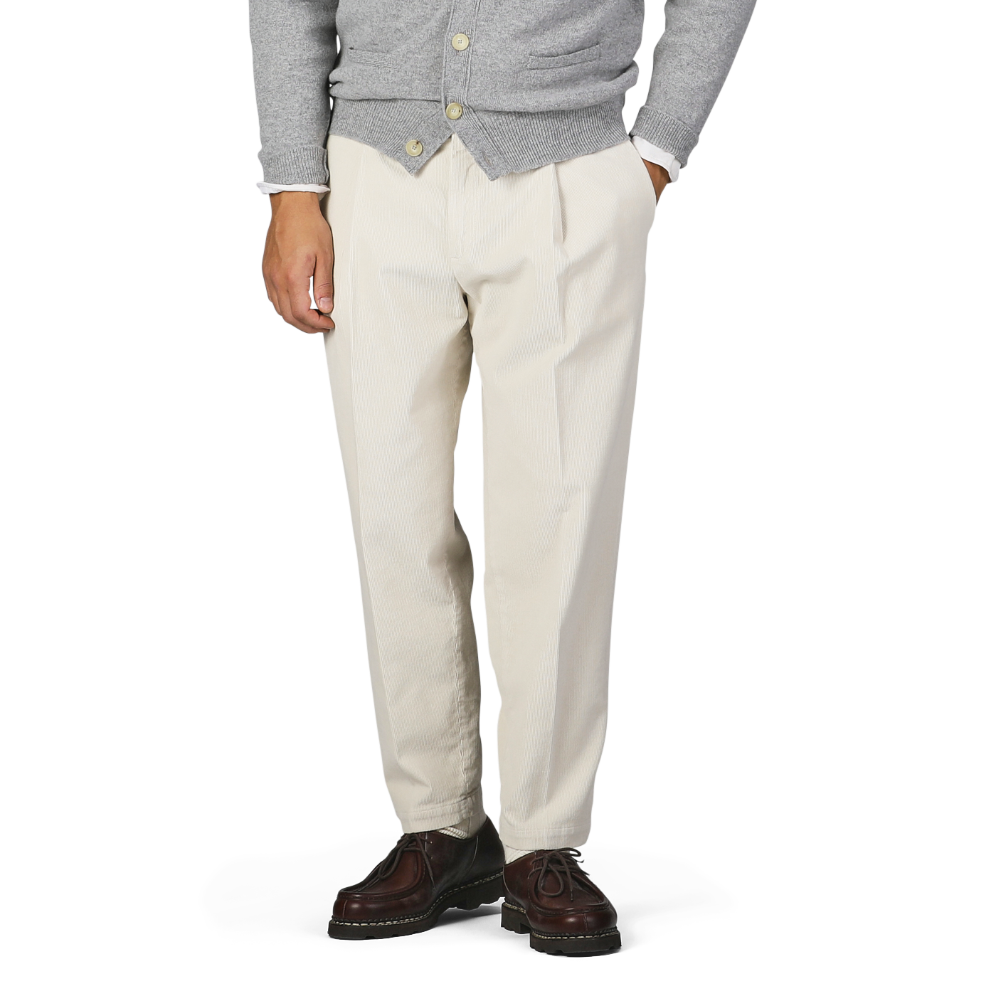 A person wearing a grey sweater with Briglia's Off-White Corduroy Courmayeur Trousers and brown shoes stands with one hand in the pocket.