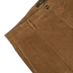 Close-up of Briglia's Tobacco Pleated Corduroy Courmayeur Trousers in sumptuous cotton corduroy, showcasing a belt loop, a button closure, and front pockets.