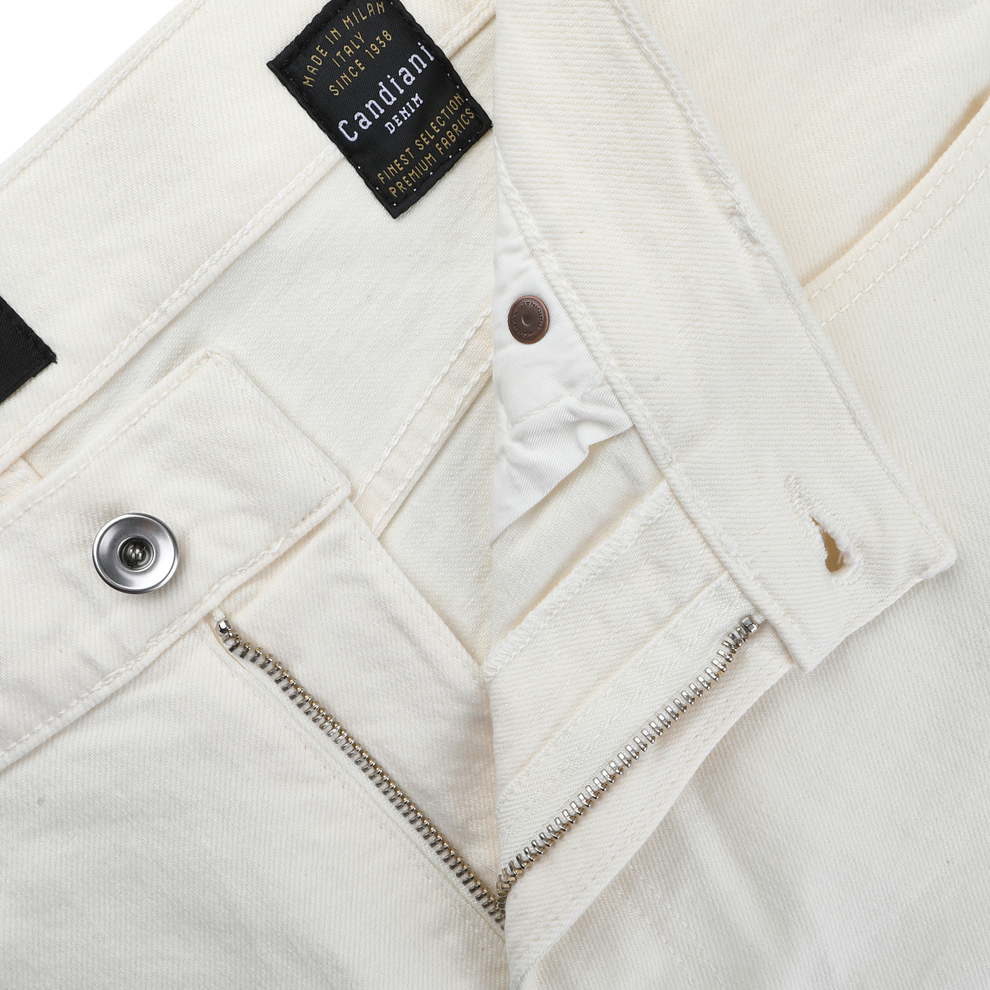 The Ecru Stone Washed Organic Cotton M8 Jeans by C.O.F Studio are made from organic Kuroki Selvedge denim and have a visible metal button and zipper. The inside black label says "Candiani," highlighting their quality craftsmanship.