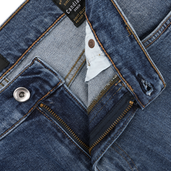 Close-up of C.O.F Studio's Indigo Blue Washed Organic Cotton M8 Jeans, showcasing a partially open zipper and metal button. Tags and stitching details emphasize the craftsmanship of the organic Kuroki Selvedge denim.