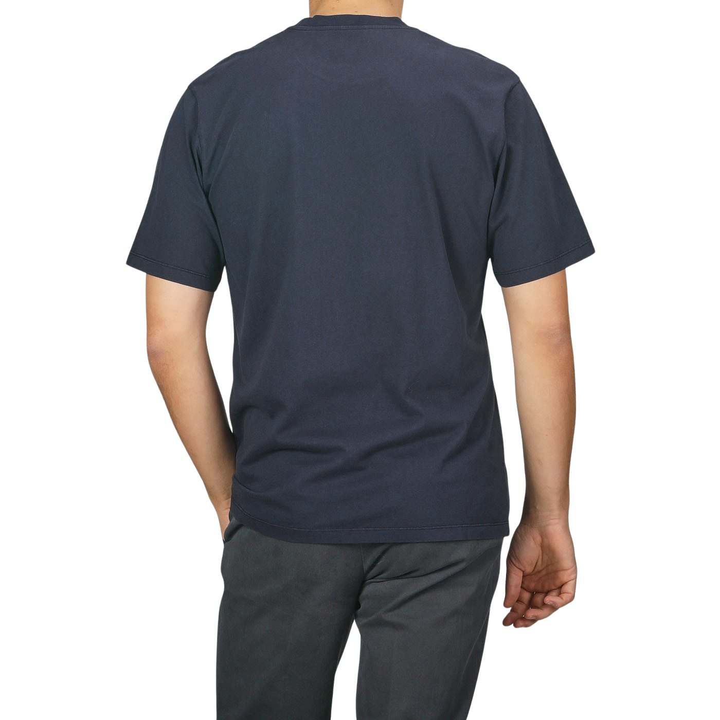 A person is standing with their back to the camera, wearing a C.O.F Studio Navy Blue Organic Cotton Crewneck T-Shirt and dark pants.