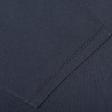 Close-up of a neatly stitched sleeve hem on the C.O.F Studio Navy Blue Organic Cotton Crewneck T-Shirt. The fabric appears smooth and uniformly colored, reflecting the quality of this regular fit garment.