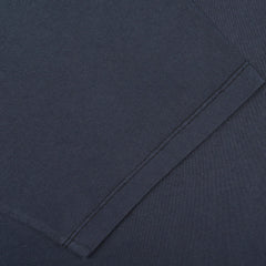 Close-up of a neatly stitched sleeve hem on the C.O.F Studio Navy Blue Organic Cotton Crewneck T-Shirt. The fabric appears smooth and uniformly colored, reflecting the quality of this regular fit garment.