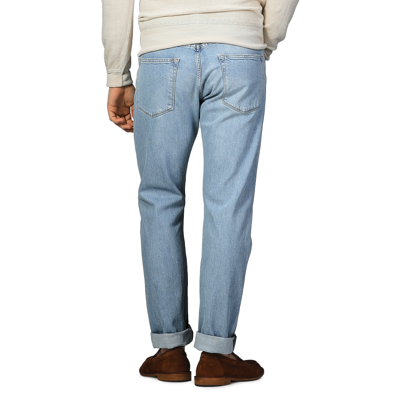 Rear shot of someone in C.O.F Studio's Light Blue 90's Wash Organic Cotton M8 Jeans, matched with brown shoes and a beige top.