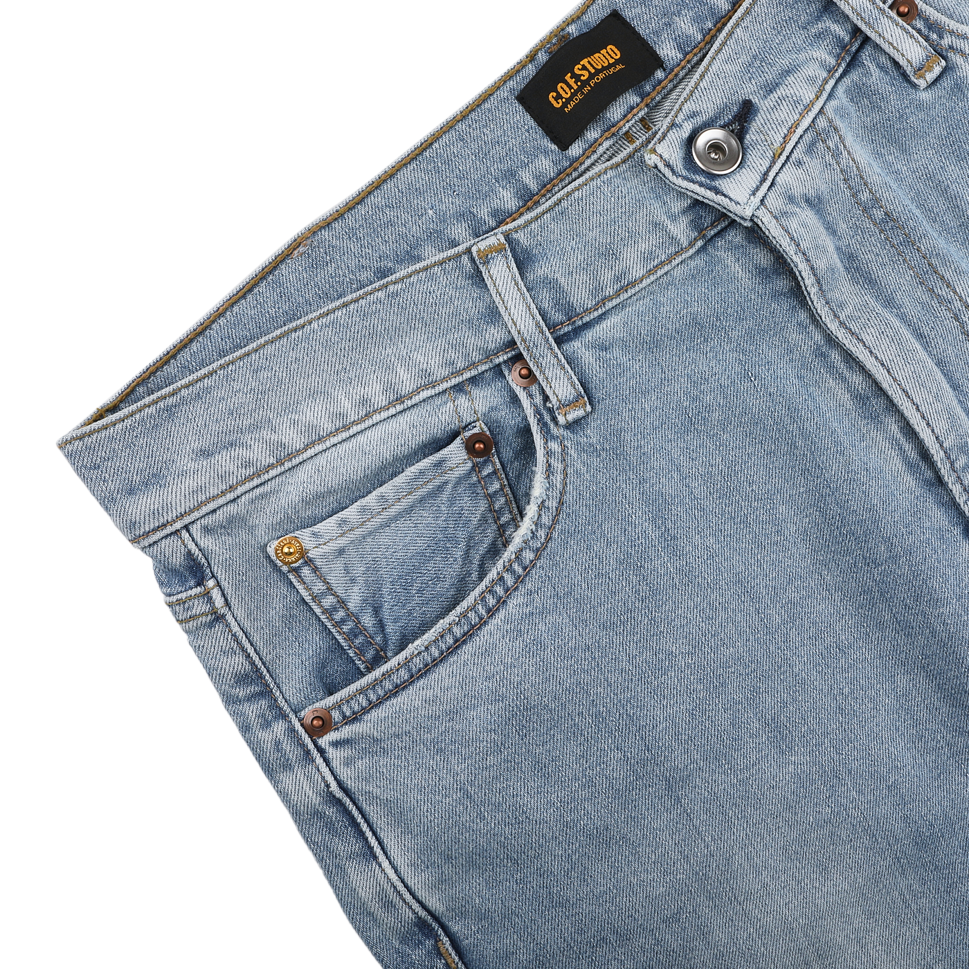 Light blue 90's wash organic cotton M8 jeans by C.O.F Studio with a straight roomy fit, front pocket, belt loops, and metal button at the waist, made from organic Kuroki Selvedge denim.