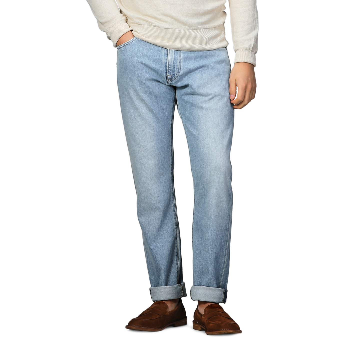 A person is wearing C.O.F Studio's Light Blue 90's Wash Organic Cotton M8 Jeans, featuring a straight roomy fit with rolled cuffs. The look includes a beige long-sleeve shirt and brown shoes, with hands in pockets.