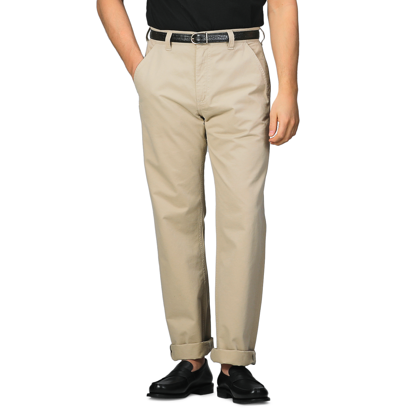 A person wearing C.O.F Studio's Sand Double Twisted Cotton Twill Fatigue Pants, accented with a black belt and shoes, stands with hands in pockets against a plain background.