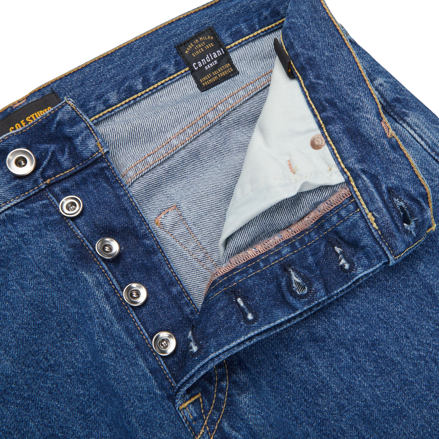 A close up of a pair of Blue Organic Candiani Cotton M6 6x Wash Jeans made from organic cotton, with buttons, by C.O.F Studio.